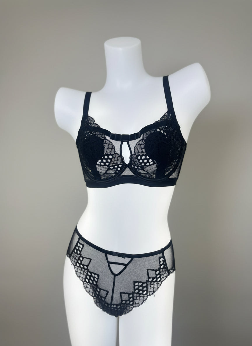 Black lace lingerie set on a mannequin against a neutral background